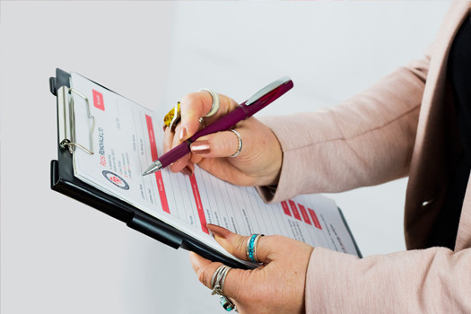 Reds removals staff holding up removal form during costing a house removal