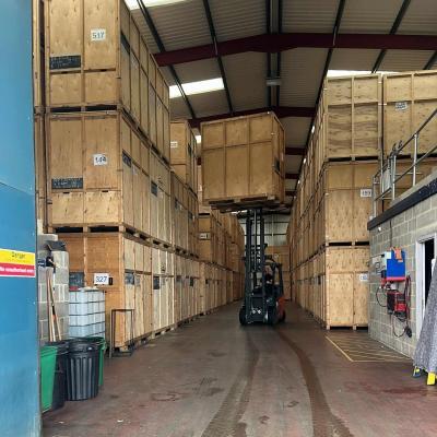 Reds Removals Forklift moving a large wooden storage container Secure indoor containerised storage